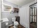 Neutral bathroom featuring wood look flooring and a shower/tub combo with a privacy curtain at 8035 Hillman Ave, Punta Gorda, FL 33982