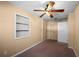 Bedroom with soft carpet, built-in shelves, and natural light, with ample closet space at 8035 Hillman Ave, Punta Gorda, FL 33982