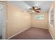 Cozy bedroom with neutral walls, plush carpet, and a window for natural lighting at 8035 Hillman Ave, Punta Gorda, FL 33982