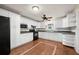 Bright kitchen features white cabinetry, updated appliances, and decorative wood tile flooring at 8035 Hillman Ave, Punta Gorda, FL 33982