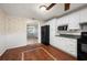 Bright kitchen features white cabinetry, updated appliances, and decorative wood tile flooring at 8035 Hillman Ave, Punta Gorda, FL 33982