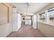 Spacious laundry room with washer, dryer, storage cabinets, and natural light from windows at 8035 Hillman Ave, Punta Gorda, FL 33982