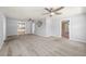 Spacious living room featuring plush carpet, neutral walls, multiple ceiling fans, and doorways for great flow at 8035 Hillman Ave, Punta Gorda, FL 33982