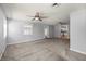 Bright living room with neutral walls, plush carpet, ceiling fans, and large windows creating a inviting space at 8035 Hillman Ave, Punta Gorda, FL 33982