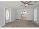 Bright living room with neutral walls, plush carpet, ceiling fan, and an inviting open floor plan at 8035 Hillman Ave, Punta Gorda, FL 33982