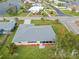 Aerial view of the home showcasing the well-manicured lawn and nearby waterfront community at 916 S Gondola Dr, Venice, FL 34293