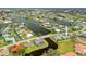 Stunning aerial view of a waterfront home surrounded by canals and lush landscaping in a desirable neighborhood at 916 S Gondola Dr, Venice, FL 34293