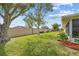 Green backyard featuring a privacy fence, well-maintained lawn, and lush landscaping at 916 S Gondola Dr, Venice, FL 34293