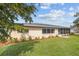 Home exterior with a well-maintained lawn, landscaping, and a screened-in porch at 916 S Gondola Dr, Venice, FL 34293