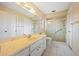 Bright bathroom with a large vanity, white cabinets, and glass-enclosed shower at 916 S Gondola Dr, Venice, FL 34293