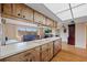 Bright kitchen featuring ample counter space, wood cabinets, and an open view to the living area at 916 S Gondola Dr, Venice, FL 34293