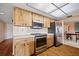Clean kitchen features stainless steel appliances, wood cabinets, and an eat-in space at 916 S Gondola Dr, Venice, FL 34293