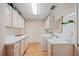 Spacious laundry room boasts ample cabinet storage, counter space, and modern washer and dryer at 916 S Gondola Dr, Venice, FL 34293