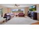 Bright living room featuring leather sofas, a neutral carpet, and a large window with neighborhood views at 916 S Gondola Dr, Venice, FL 34293