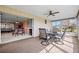 Bright sunroom with glass windows, ceiling fan, and access to both the interior and exterior at 916 S Gondola Dr, Venice, FL 34293