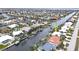 Aerial view of a canal-front neighborhood with lush landscaping and private boat docks at 931 Bal Harbor Blvd, Punta Gorda, FL 33950