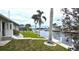 Backyard view with a waterfront setting and lush tropical landscaping and a boat dock at 931 Bal Harbor Blvd, Punta Gorda, FL 33950