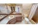 Bathroom featuring dual sinks, a toilet, and a shower with tile flooring at 931 Bal Harbor Blvd, Punta Gorda, FL 33950