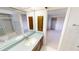 Bright bathroom with a large mirror, vanity, and a view to the bedroom at 931 Bal Harbor Blvd, Punta Gorda, FL 33950