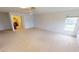 Bright bedroom featuring carpet floors, a ceiling fan, and access to the bathroom at 931 Bal Harbor Blvd, Punta Gorda, FL 33950
