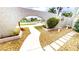 Courtyard entrance with an arched privacy wall and tropical landscaping at 931 Bal Harbor Blvd, Punta Gorda, FL 33950