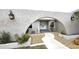 Home entrance with a walkway, decorative stone, and an arched privacy wall at 931 Bal Harbor Blvd, Punta Gorda, FL 33950
