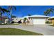 Charming home with a well-maintained yard, paved driveway, and attached garage at 931 Bal Harbor Blvd, Punta Gorda, FL 33950