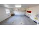 Spacious two-car garage with white walls, an automatic door, and some workbenches at 931 Bal Harbor Blvd, Punta Gorda, FL 33950