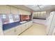 Spacious kitchen with ample counter space, white cabinets, and an open layout to the lanai at 931 Bal Harbor Blvd, Punta Gorda, FL 33950