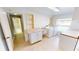 Well-lit laundry room with storage cabinets, countertop, and a modern washer and dryer set at 931 Bal Harbor Blvd, Punta Gorda, FL 33950