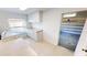 View of laundry room featuring white cabinets, countertops, a window, and access to the garage at 931 Bal Harbor Blvd, Punta Gorda, FL 33950