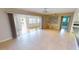 Open-concept living room featuring sliding glass doors and decorative built-in shelves at 931 Bal Harbor Blvd, Punta Gorda, FL 33950