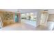 Open living area with tiled flooring, adjacent to the kitchen with white cabinetry at 931 Bal Harbor Blvd, Punta Gorda, FL 33950