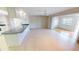 Bright living space with a breakfast bar looking into the living room with sliding doors at 931 Bal Harbor Blvd, Punta Gorda, FL 33950
