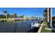 Beautiful waterfront views with palm trees, boat docks, and houses under a blue sky at 931 Bal Harbor Blvd, Punta Gorda, FL 33950