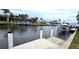 Waterfront views showcasing a dock, boat lift, and houses along the canal at 931 Bal Harbor Blvd, Punta Gorda, FL 33950