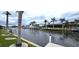 Scenic waterfront views with palm trees, boat docks, and homes in the distance at 931 Bal Harbor Blvd, Punta Gorda, FL 33950