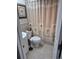 Bathroom with a white vanity, toilet, and a decorative shower curtain at 22480 Oceanside Ave, Port Charlotte, FL 33952