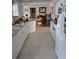 Bright kitchen featuring white cabinets, a tile floor, and a cozy breakfast bar area at 22480 Oceanside Ave, Port Charlotte, FL 33952
