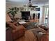Cozy living area with hardwood floors, a ceiling fan, and comfortable leather furniture at 22480 Oceanside Ave, Port Charlotte, FL 33952