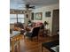 Cozy living area with wood floors, comfortable seating, and lots of decorative photos at 22480 Oceanside Ave, Port Charlotte, FL 33952