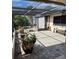 A patio with brick pavers, screening, a chiminea, and a bench offers outdoor living space at 22480 Oceanside Ave, Port Charlotte, FL 33952
