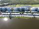 Overhead view of condo building, showcasing parking, nearby pond, and beautiful landscaping at 14081 Heritage Landing Blvd # 232, Punta Gorda, FL 33955