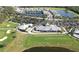 Stunning aerial view of the clubhouse, golf course, and community with lush landscaping and serene lakes at 14081 Heritage Landing Blvd # 232, Punta Gorda, FL 33955