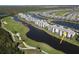Aerial perspective of condo complex by the water with golf course in the background at 14081 Heritage Landing Blvd # 232, Punta Gorda, FL 33955