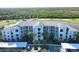 Stunning aerial view of condo complex with lush landscaping, golf course, and lake views at 14081 Heritage Landing Blvd # 232, Punta Gorda, FL 33955