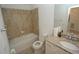 Full bathroom featuring granite top vanity, toilet, and tiled shower-tub combination at 14081 Heritage Landing Blvd # 232, Punta Gorda, FL 33955