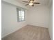 Bright bedroom featuring neutral carpet, ceiling fan, and a sunlit window at 14081 Heritage Landing Blvd # 232, Punta Gorda, FL 33955
