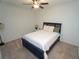 Cozy bedroom with ceiling fan, carpeted floors, and a comfortable queen-sized bed at 14081 Heritage Landing Blvd # 232, Punta Gorda, FL 33955