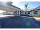 Covered entrance of the clubhouse with pristine landscaping and elegant architecture, showcasing a welcoming arrival experience at 14081 Heritage Landing Blvd # 232, Punta Gorda, FL 33955